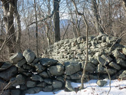Stone walls along the Catfish Loop Trail with the Hudson Highlands visible. Photo by Daniel Chazin.