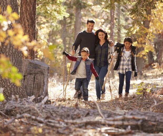 A family enjoys a fall hike. Photo credit: Adobe Stock