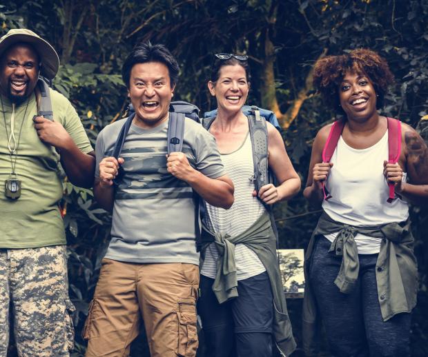 A group photo of hikers smiling. Photo by Adobe Stock.