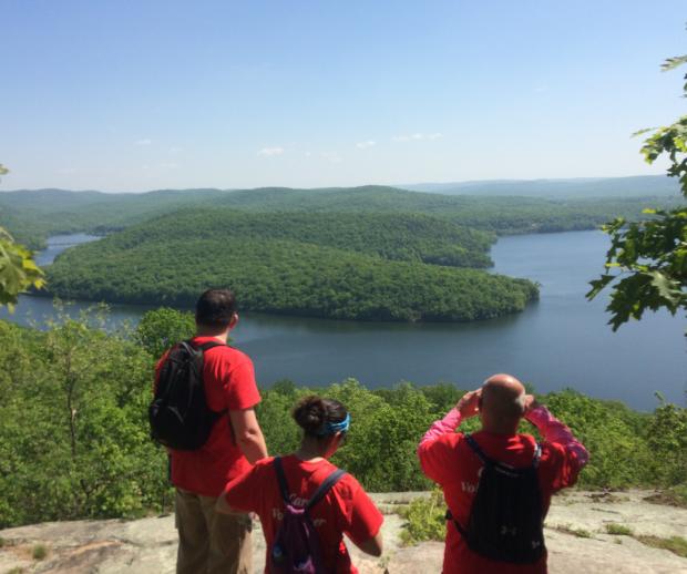 Hikers enjoy a scenic overlook of a lake in Norvin Green State Forest. Photo by Peter Dolan.